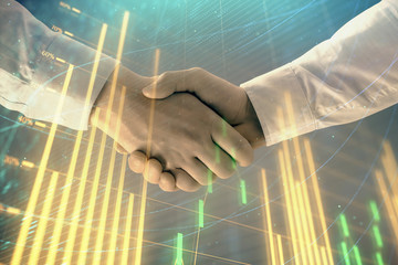 Multi exposure of forex graph on abstract background with two businessmen handshake. Concept of success on stock market