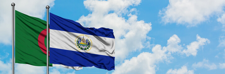 Algeria and El Salvador flag waving in the wind against white cloudy blue sky together. Diplomacy concept, international relations.