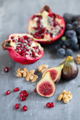 pomegranate and figs on ceramic background