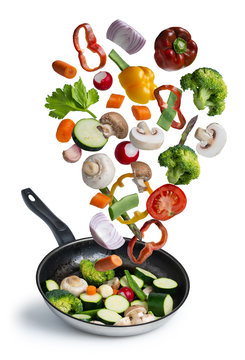 grilled fresh vegetables flying isolated on white background - image