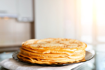 Stack of fresh pancakes on the kitchen table.