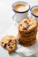 coffee and cookies with chocolate chips on ceramic background