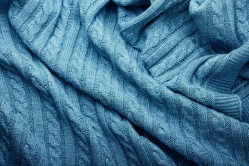 Folds of a knitted woolen blanket, top view