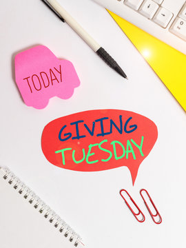 Text sign showing Giving Tuesday. Business photo showcasing international day of charitable giving Hashtag activism Red bubble copy space paper on the table with clock