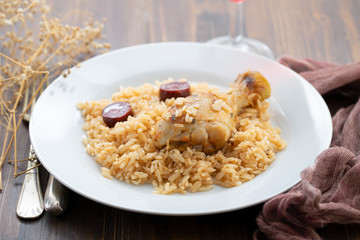 chicken with smoked sausage and rice on white plate
