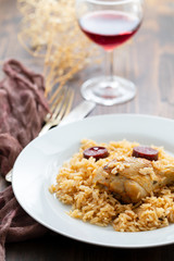 chicken with smoked sausage and rice on white plate