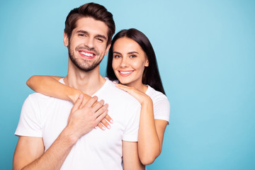 Close-up portrait of his he her she nice-looking attractive charming lovely cute sweet cheerful cheery couple hugging isolated over bright vivid shine vibrant blue green turquoise background