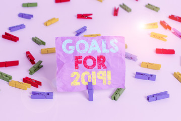 Writing note showing Goals For 2019. Business concept for object of demonstratings ambition or effort aim or desired result Colored clothespin papers empty reminder white floor background office