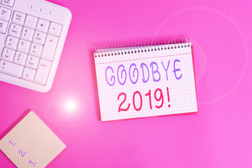 Text sign showing Goodbye 2019. Business photo showcasing express good wishes when parting or at the end of last year Writing equipments and computer stuffs placed above classic wooden table