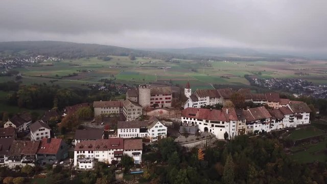 Top down aerial of amazing old castle architecture on misty day.