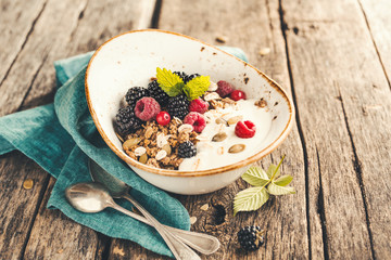 Delicious and healthy Breakfast with homemade granola. Selective focus.