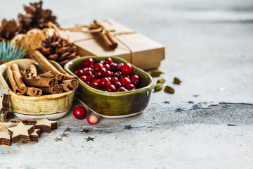 Christmas background with fir branches, cones, cinnamon and cranberries. Christmas  background concept.