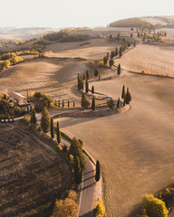 Aerial drone landscape of famous Tuscany hills, Italy. Abstract view of curved serpentine road with...