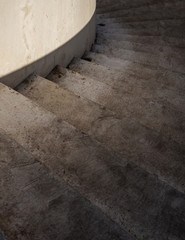 Concrete starirway with dirty steps in curve