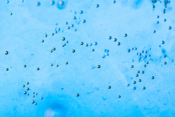 Abstract colorful background. Foam of Soap with Bubbles macro shot. Closeup bubbles in water. Oil...