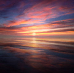 Fototapeta na wymiar Mirrored Glowing Sky Sunset on beach in North Cornwall