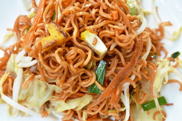 fried instant noodles with tofu and garlic chive on plate