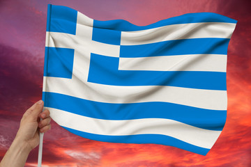 Obraz premium National flag of the country Greece on delicate silk with wind folds, travel concept, immigration, politics, copy space, close-up