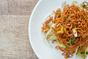 fried instant noodles with tofu and garlic chive on plate