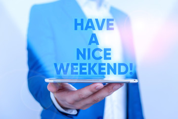 Writing note showing Have A Nice Weekend. Business concept for wishing someone that something nice happen holiday Man in the blue suite and white shirt holds mobile phone in the hand