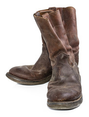 A pair of old, dirty, brown cowboy boots that are separated on a white background.