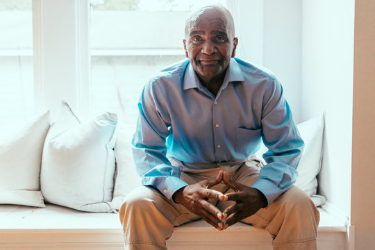 Portrait of senior man sitting near window