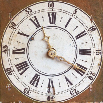 Ancient clock with weathered brown background