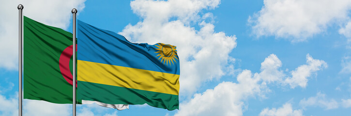 Algeria and Rwanda flag waving in the wind against white cloudy blue sky together. Diplomacy concept, international relations.
