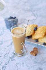 prepares coffee with milk with ciabatta in his coffee shop