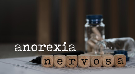 Word ANOREXIA NERVOSA composed of wooden dices. - obrazy, fototapety, plakaty