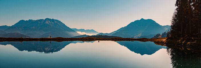 Beautiful alpine view with reflections in a lake at Fieberbrunn, Tyrol, Austria