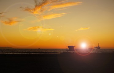 Beach sunset with bright sun and lens flares
