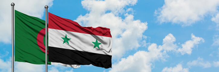 Algeria and Syria flag waving in the wind against white cloudy blue sky together. Diplomacy...