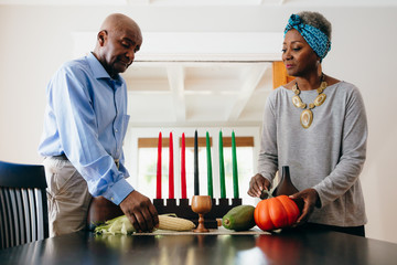 Grandparents arranging Kwanzaa set