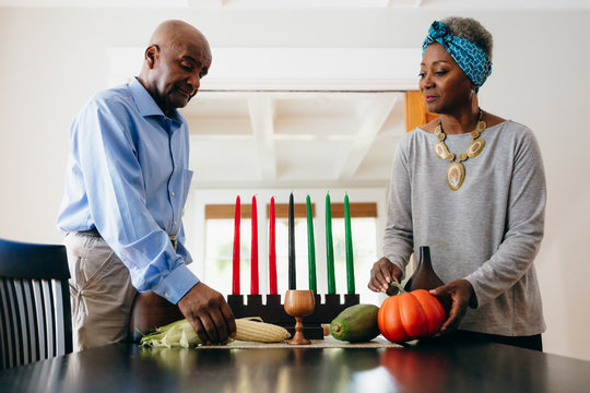 Grandparents arranging Kwanzaa set