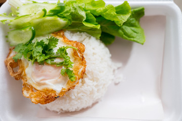 The inner box of rice is fried egg on top white rice.