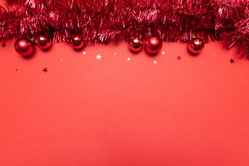 Christmas composition with Christmas tinsel on red background. Christmas, winter, new year concept....