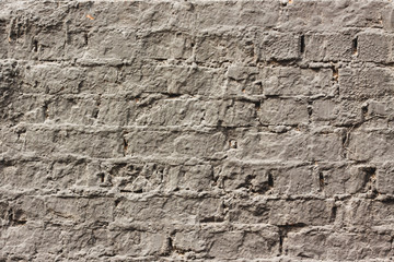an old brick wall covered in gray paint