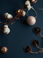Christmas flatlay on navy background. Cotton, holiday decoration. New year decorated mock up, copy space, top view.