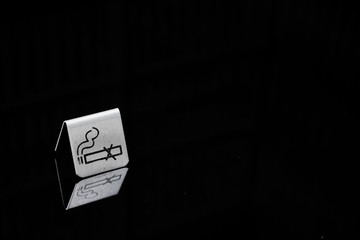 no smoking sign.  Non smoking table sign made from metal (metal table sign) with its reflection on...