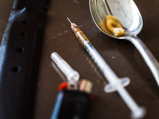 Dirty syringe and other items for intravenous drug use. Imitation.