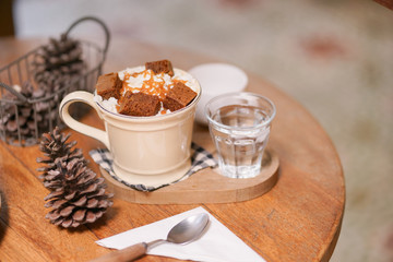 Hot chocolate. A cup of hot chocolate with selective focus on the whipping cream and caramel sauce.