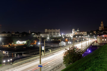 Fototapeta na wymiar Embankment, the Neman River and the Old Bridge in Grodno. Night view of the city and the Old Bridge