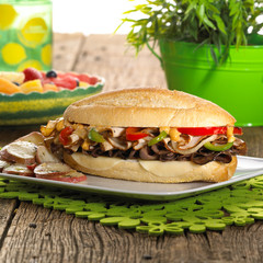 Turkey and roast beef cheesesteak with peppers and onion on a plate