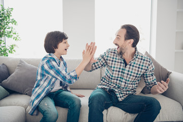 Portrait of two nice attractive cheerful cheery excited guys dad and son clapping palms making...