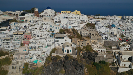 Aerial drone photo of iconic picturesque village of Imerovigli built on top of steep hill with amazing views to Caldera and Santorini island, Cyclades, Greece