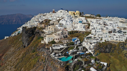 Aerial drone photo of iconic picturesque village of Imerovigli built on top of steep hill with...