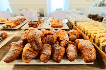Sweet french croissants pastry with jam and cream