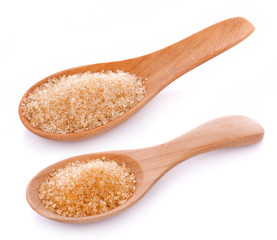 Brown sugar in wooden spoon on white background