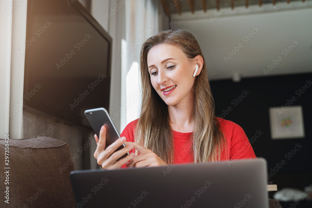 Wall mural Young woman texting on mobile phone. Girl checking email on smartphone. Digital tools and opportunities for mobile users, apps, video channels, entertaining content and social media pages to subscribe